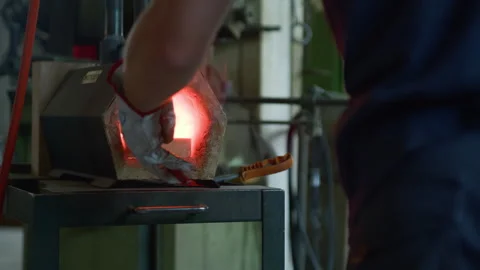 Blacksmith Removing Hot Metal from Forge with Tongs – Glowing Iron in Workshop Stock Footage 313846786