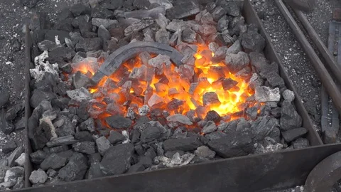 A blacksmith sets up a brazier heating flame. Stock Footage 120572901