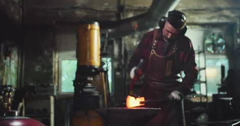 The blacksmith shapes the workpiece with a hammer Stock-Footage 165449974