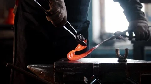 Blacksmith shaping hot metal on anvil Stock Footage 304977417