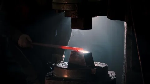 Blacksmith shaping metal with power hammer Stock Footage 304977677
