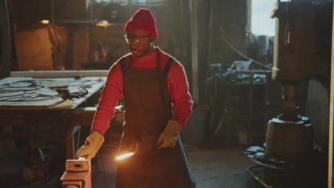 Blacksmith Shaping Red-Hot Metal Workpiece with Sledgehammer on Anvil Stock Footage 274390042