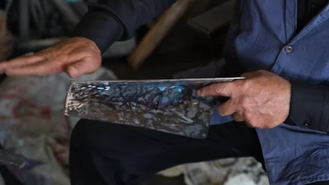 Blacksmith Sharpening Axe In Workshop With Grinder Sparks, August 20,2021, Stock Footage 324566604