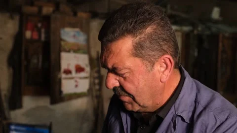 Blacksmith Sharpening Axe In Workshop With Grinder Sparks, August 20,2021, Stock Footage 324566700