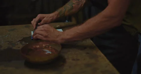 Blacksmith is sharpening blade of ancient knife by grindstone, closeup view, 4K Stock Footage 205158435