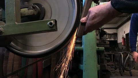 Blacksmith sharpening the knife on grinding stone Stock Footage 168690737