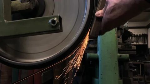 Blacksmith sharpening the knife on grinding stone Stock Footage 168690801
