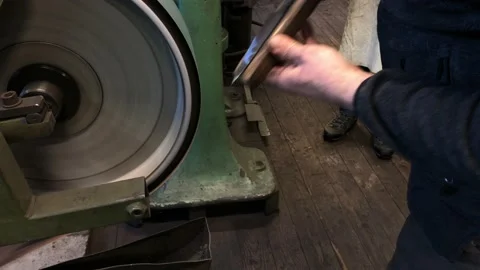 Blacksmith sharpening the knife on grinding stone Stock Footage 168690861