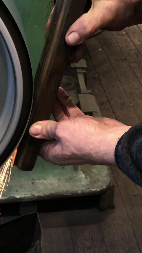 Blacksmith sharpening the knife on grinding stone Stock Footage 249453949
