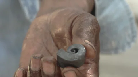 Blacksmith shows piece of metal Vídeo Stock 243858352