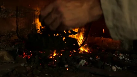 Blacksmith Sprinkles Small Coals on Burning Coals in the Furnace. Stock Footage 271153520