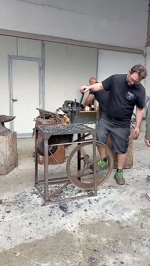 Blacksmith stokes the embers Stock Footage 289080933