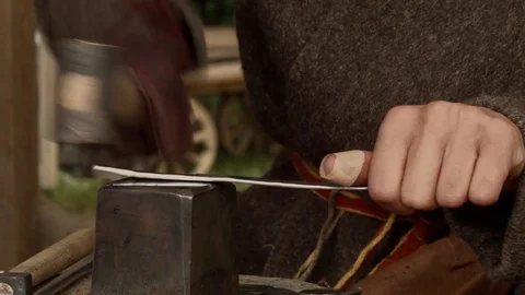 The blacksmith strikes the hammer on metal Stock Footage 70548436