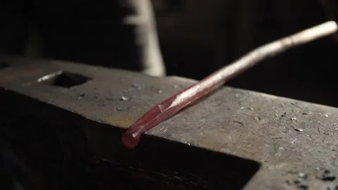 Blacksmith Strikes A Hot Iron with a Hammer Stock Footage 134206705
