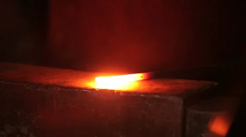 Blacksmith strikes red hot iron, sparks fly, closeup Stock Footage 39014928