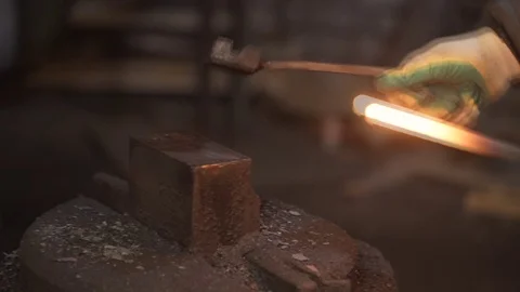 Blacksmith strikes red hot iron, sparks fly. Stock Footage 73352282