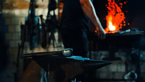 Blacksmith take a blank from fire and forge on anvil and furnace on background Video stock 127882659