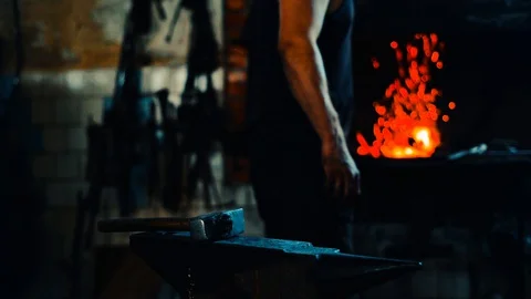 Blacksmith take a blank from fire and forge on anvil and furnace on background Video stock 127882660