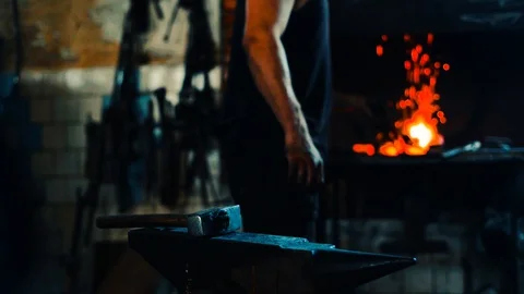 Blacksmith take a blank from fire and forge on anvil and furnace on background Video stock 127882702