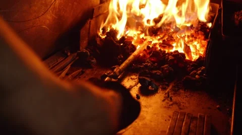 Blacksmith takes metal out of fire, smithwork Stock Footage 44448350