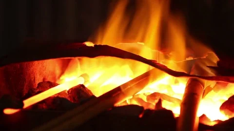 Blacksmith takes metal out of fire, close up Stock Footage 72218946