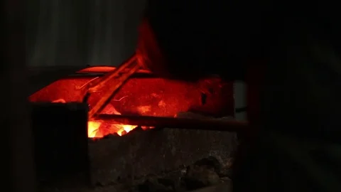 Blacksmith takes metal out of fire, smith work Stock-Footage 72219841