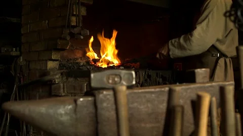 Blacksmith Takes out Rod from the Fire and Begins to Forge it on the Anvil. Stock Footage 271153517