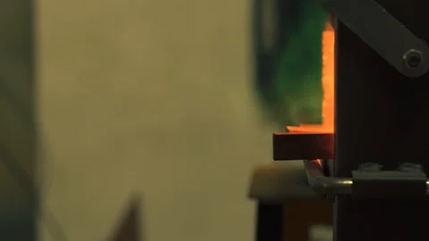 Blacksmith taking out a molten metal object from the forge Stock Footage 128597002
