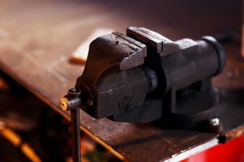Blacksmith tools. Old vise in a forge shop Stock Photos
