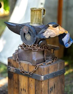 Blacksmith tools set with heavy iron anvil hammer and tongs on workbench Stock-Fotos