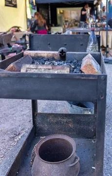Blacksmith tools set with heavy iron anvil hammer and tongs on workbench Stock Photos
