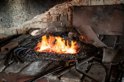 Blacksmith tools, traditional craft. Fire in the furnace. Smithy Stock Photos