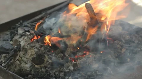 Blacksmith turning bronze already charred coffee maker on live coals Stock-Footage 7769205