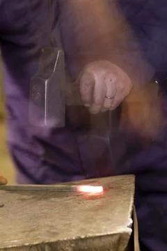 Blacksmith uses a hammer Stock Photos