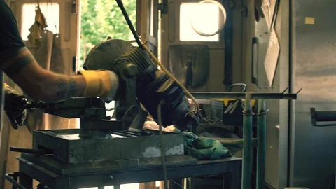 Blacksmith using a circular saw Stock Footage 128597218