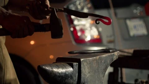 Blacksmith is using hammer to forge metal, Close-up of a Man Making Handicrafts Stock Footage 251674164
