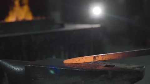 Blacksmith is using hammer to forge metal Video stock 298871079