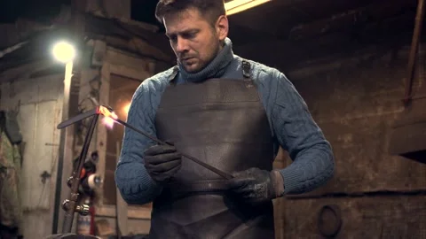 Blacksmith using welding torch for heating metal Stock Footage 132652956