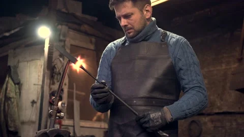 Blacksmith using welding torch in workshop Stock Footage 132652928