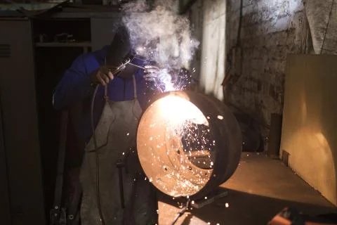 Blacksmith using a welding torch in workshop Stock Photos