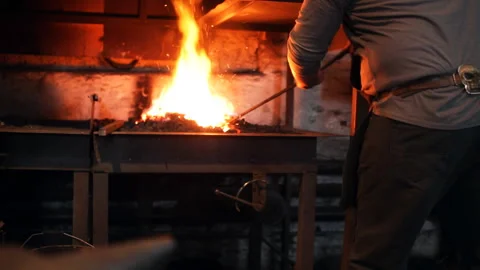 Blacksmith warms the stove Stock Footage 100233993