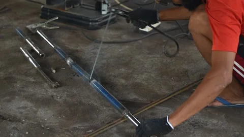 Blacksmith welder in protective mask works with metal steel and iron using a  Vídeo Stock 149900157