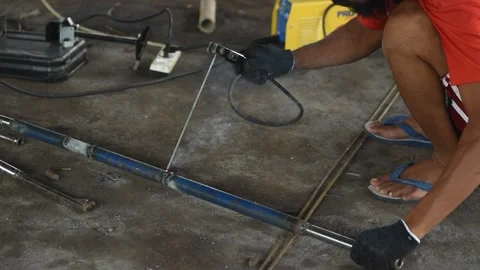 Blacksmith welder in protective mask works with metal steel and iron using a  Stock Footage 149900185