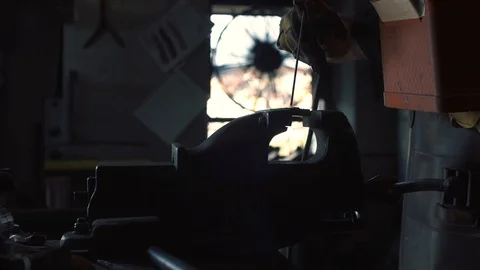 Blacksmith welding metal in the workshop Stock Footage 128597839