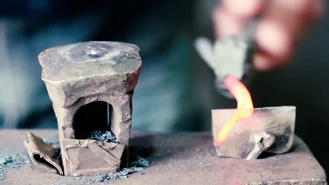 Blacksmith work. Blacksmith beats a piece of white hot metal with a hammer on an Stock Footage 76373711
