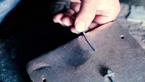 Blacksmith work. Blacksmith beats a piece of white hot metal with a hammer on an Stock Footage 76373765