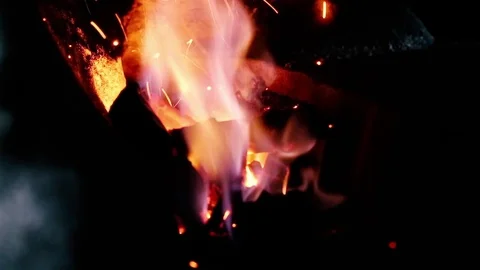 Blacksmith work. Blacksmith beats a piece of white hot metal with a hammer on an Stock Footage 76373773