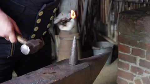 Blacksmith working with anvil and hammer in smithy Stock Footage 95071269