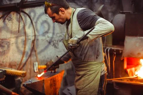 Blacksmith working on an anvil Stock Photos