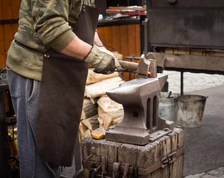 Blacksmith working with anvil Stock Photos